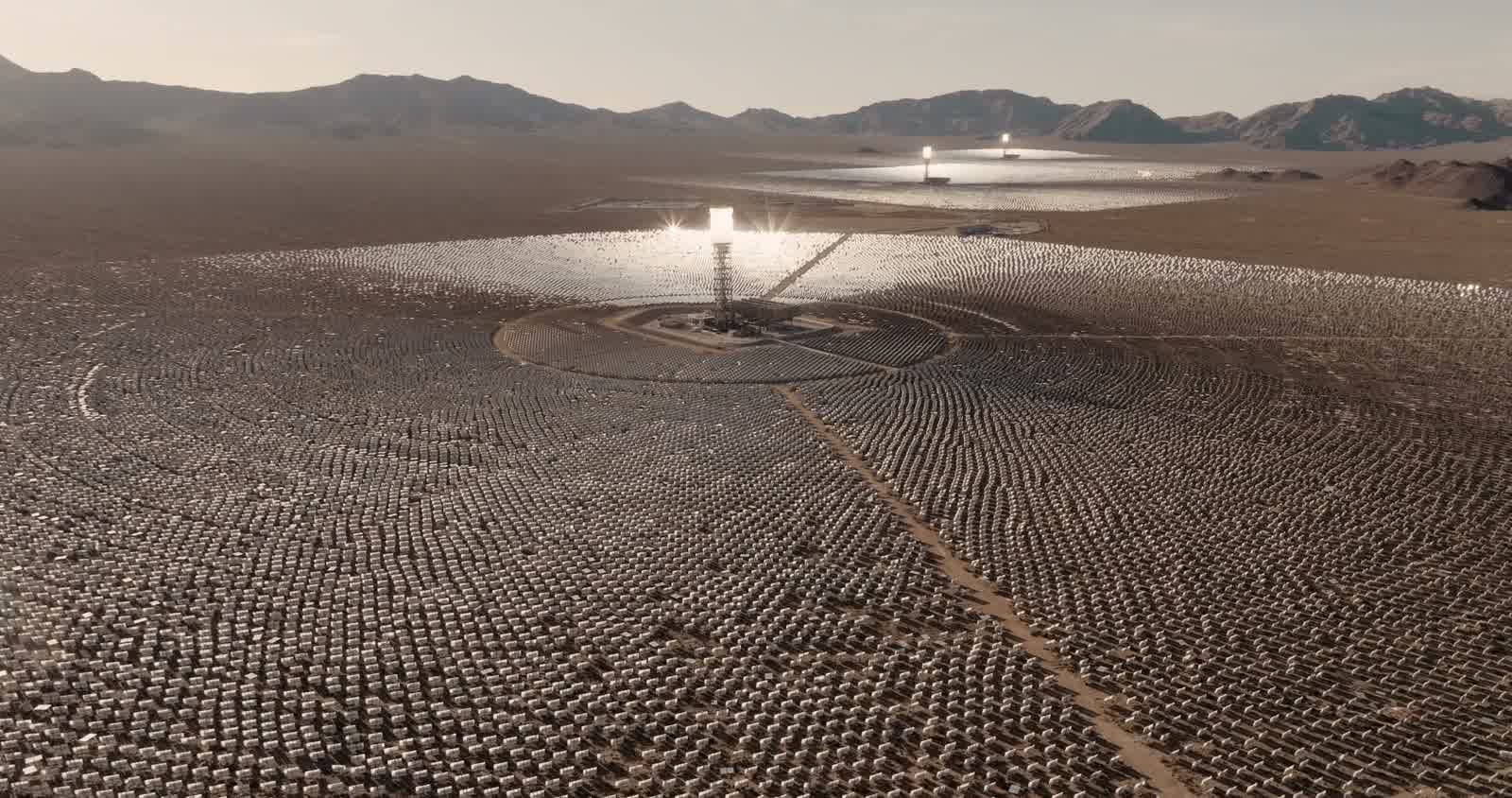 A solar field in the desert seen from above, the tower glowing at the centre of its rings of mirrors